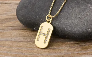 Gold-plated 18K letter H pendant necklace with sparkling zircons on a delicate box chain.