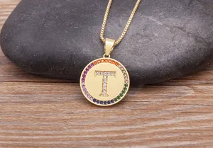 Gold-plated copper necklace featuring a round letter T pendant inlaid with colorful zirconia.