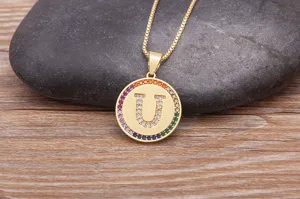 Gold-plated copper initial U pendant necklace featuring colorful cubic zirconia halo details.