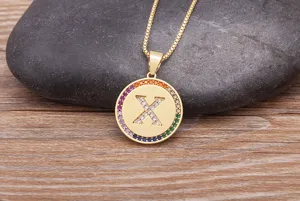 Gold-plated copper alphabet X pendant necklace with colorful micro-set cubic zirconia.