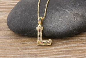 Gold color letter L pendant necklace with colorful cubic zirconia stones. Detailed close-up view.