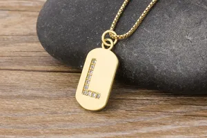Detailed close-up view of gold initial letter L pendant necklace with sparkling zirconia stones.