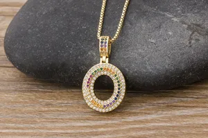 Close-up detail of a gold-plated circular pendant necklace featuring colorful pavé cubic zirconia.