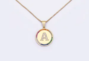 Gold letter A pendant necklace detail close-up showcasing colorful zircon rim pavé crystal.
