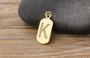 Gold letter K pendant detail shot, minimalist brass 18k gold plated cubic zirconia charm.
