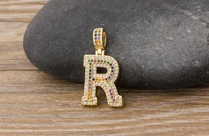 Detailed close-up of the gold-plated letter R pendant featuring colorful zirconia.