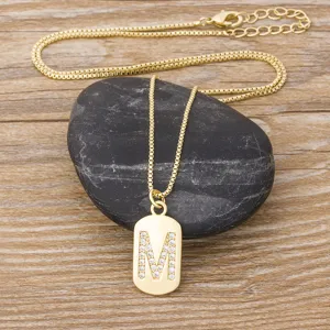 Gold plated initial letter M pendant necklace with sparkling cubic zirconia fashion jewelry.