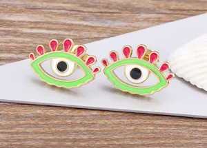 Close-up detail of creative colorful enamel evil eye stud earrings, gold plated metal finish.