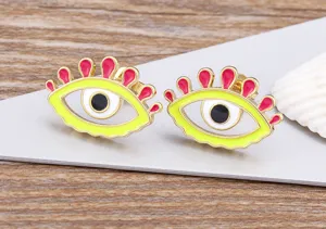 Gold plated evil eye earrings with neon yellow enamel and pink eyelashes detail.