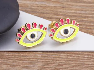 Close-up detail shot of colorful enamel evil eye stud earrings, showing fine metal craft.