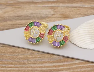 Detailed view of colorful crystal letter F stud earrings, gold plated copper with sparkling zircon.