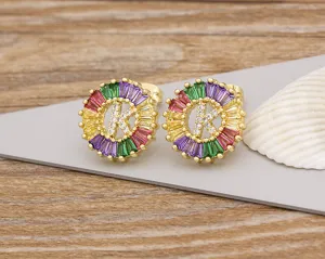 Detail shot of gold-plated letter K stud earrings featuring colorful crystal stones.