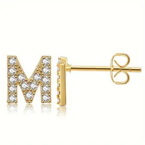 Letter M stud earrings with sparkling cubic zirconia and stainless steel post detail view.