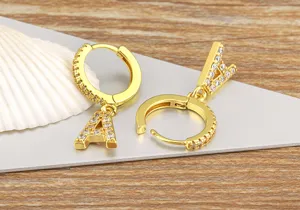 Detailed close-up of gold-plated micro-set zircon letter A hoop earrings, delicate and elegant.