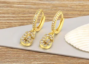 Close-up view of elegant gold letter G hoop earrings sparkling with micro-set cubic zirconia.