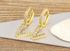 Close-up of gold-plated crystal letter V pendant hoop earrings, elegant and sparkling detail.