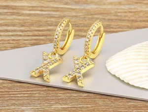Detail view of 18k gold plated cubic zirconia letter X hoop earrings for women fashion.