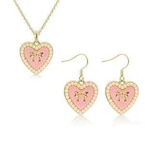 Chic pink heart pendant necklace and earrings set with faux pearls and bows for women fashion.