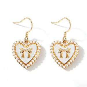 Gold heart faux pearl earrings with chic bow detail, elegant drop style fashion jewelry.