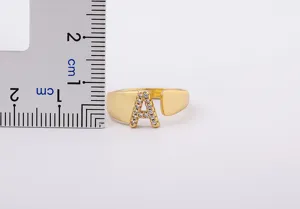 Detailed view of 18k gold plated letter ring with sparkling zircon and size reference.