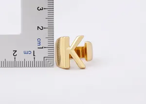 Gold letter K ring detail shot showing ring size and polished metallic surface finish.