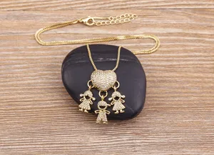 Close-up detail of the gold rhinestone heart pendant with cute children figures nicely.