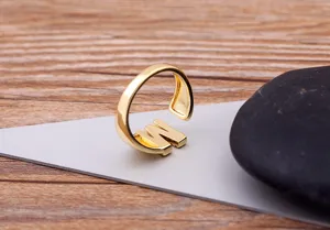 Gold plated letter W adjustable open ring detail shot, minimalist fashion finger jewelry.