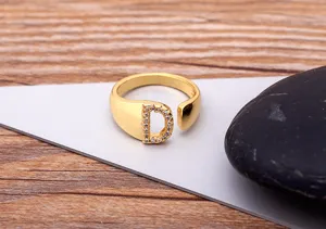 Gold plated brass alphabet D ring with sparkling cubic zirconia, elegant open finger ring accessory.