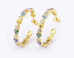 Detailed shot of gold plated multi-colored enamel evil eye heart hoop earrings with sparkling cz.