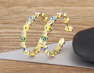 Gold-plated evil-eye heart hoop earrings minimalist fashion jewelry close-up view.