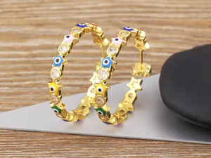 Evil eye star hoop earrings detailed view showcasing 18k gold plated copper with colorful enamel.