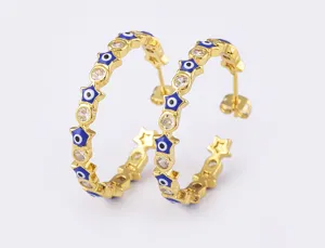 Detailed shot of 18k gold plated evil eye star hoop earrings with sparkling cubic zirconia stones.