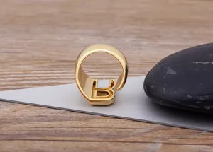 Detail shot of a gold-plated letter B adjustable ring showcasing exquisite metal texture.