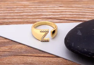 Gold-plated open ring featuring letter Z and sparkling cubic zirconia stones detail view.
