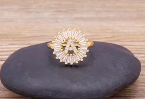 Detail shot of a gold plated letter A zirconia ring featuring baguette and round CZ stones.
