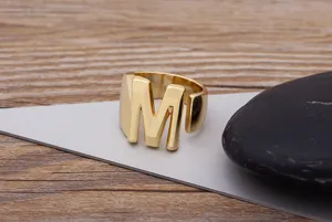 Close-up detail of a stylish gold 18k plated copper alphabet letter M open ring for daily wear.