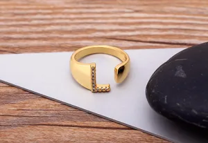 Gold plated open letter L ring detailed close-up shot featuring sparkling cubic zirconia stones.