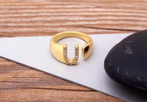 Close-up detail view of the gold-plated letter U open ring paved with sparkling cubic zirconia.