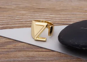 Gold plated open letter Z ring detailed close-up shot, modern geometric alphabet jewelry piece.