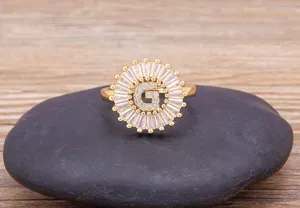 Close-up detail shot of gold plated letter G ring with sparkling cubic zirconia stones.