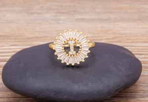Detail shot of 18K gold plated copper initial letter zircon ring, elegant circular halo design.