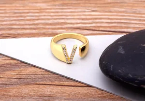 Detailed view of the 18K gold plated copper letter V open ring sparkling with zircon stones.