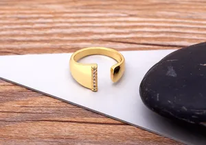 Detailed close-up view of the gold-plated open ring featuring sparkling zircon stones.