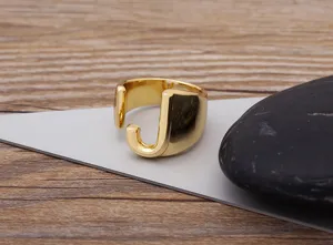 Close-up detail of a stylish gold-plated letter J open ring, minimalist unisex design.