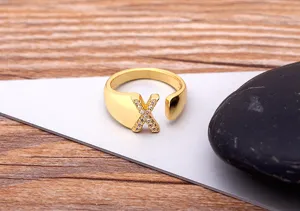 Detailed shot of gold plated copper letter X open ring with cubic zirconia for women fashion