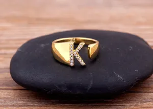 Close-up detail of the 18k gold plated adjustable initial K ring sparkling with cubic zirconia.