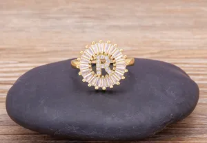 Exquisite gold-plated letter R zircon ring detail, sparkling baguette stones, elegant jewelry.