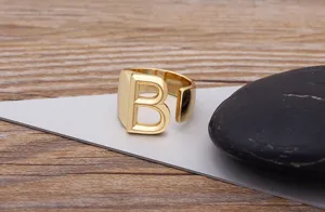 Detailed close-up view of the stylish gold initial letter B open ring on a grey display