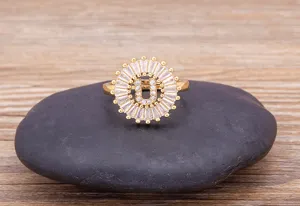 Elegant gold-plated letter U zircon ring detail, showing sparkling stones and exquisite craftsmanship on stone prop.