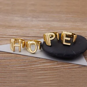 Gold plated letter rings spelling HOPE, adjustable open design, stylish couple jewelry piece.